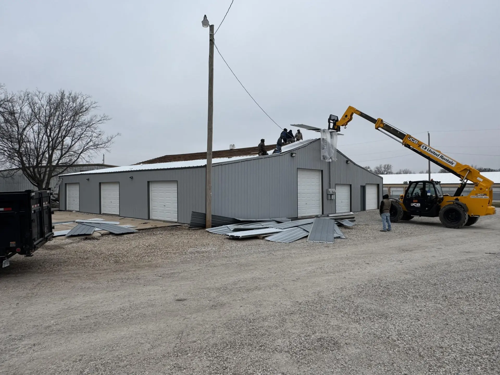 Crew installing a new metal roof on a commercial building